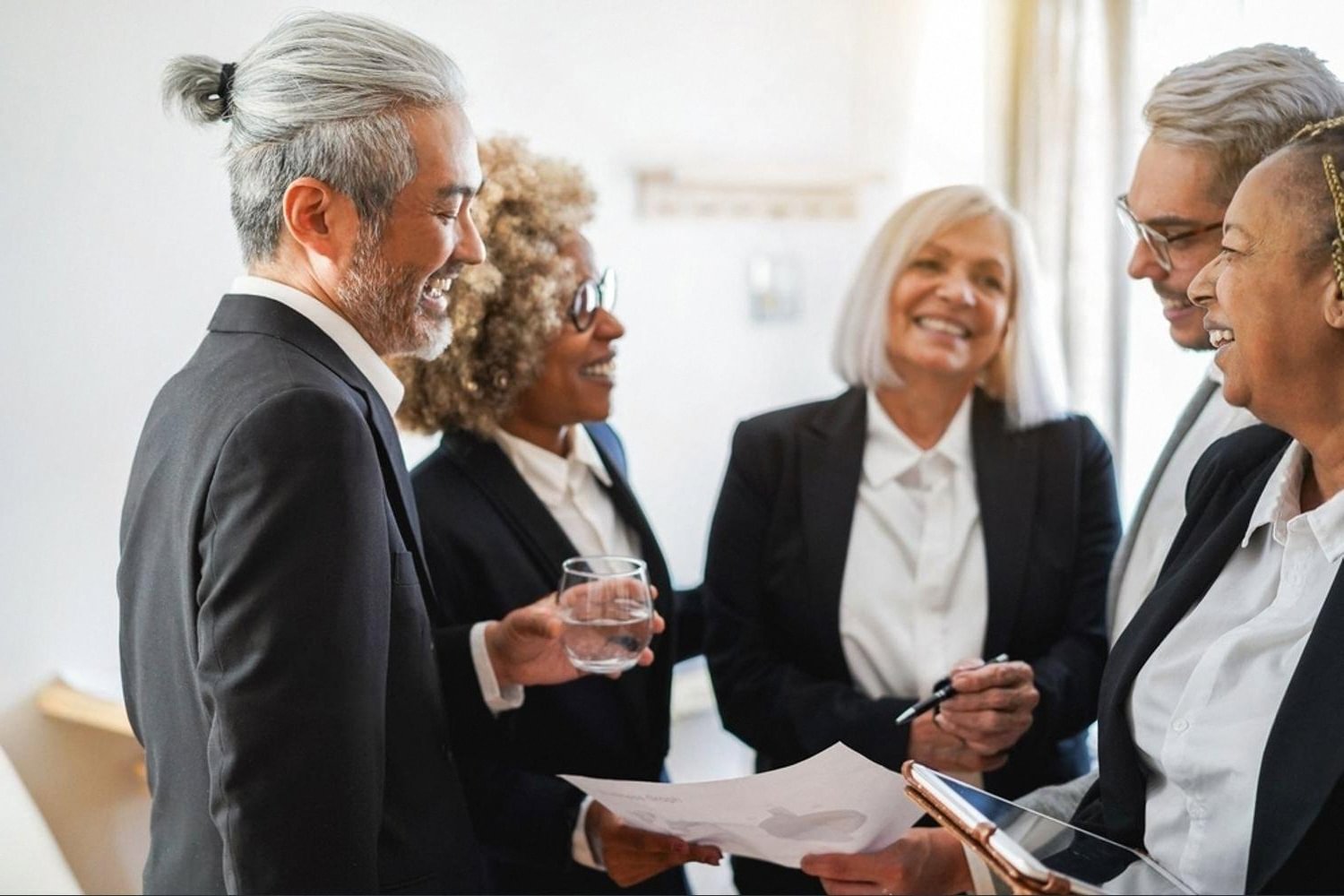 Compliance officers discussing sanctions screening results in a Dubai office