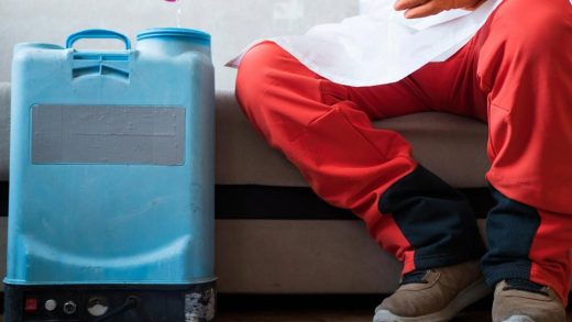 Professional pest control technician preparing a spray tank inside a Dubai home